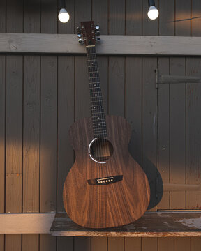 Guitars  on outdoor wooden  exterior.
