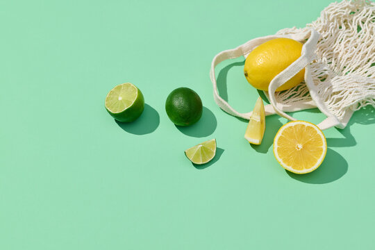The mesh bag with citrus fruits lime and lemon