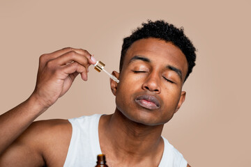 Man applying facial oil for skincare routine