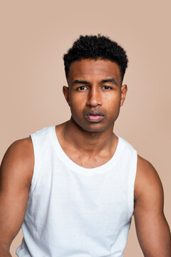 Confident young man in white tank top
