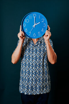 man with a clock which strikes two oclock