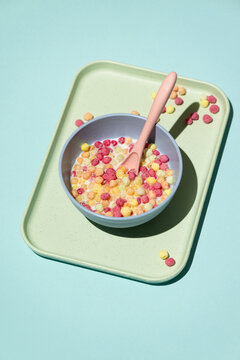 Colorful ball-shaped pop breakfast cereal on blue background