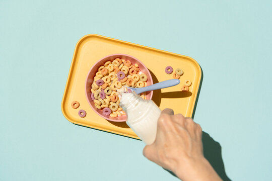 Pouring nut milk over breakfast cereal