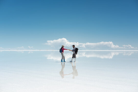 travel couple in amazing landscape of uyuni