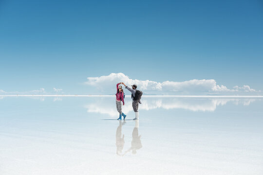 travel couple in amazing landscape of uyuni - Powered by Adobe
