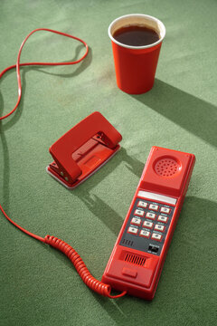 Red Telephone with Coffee on Green Background