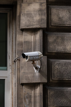 Street camera on wall in old city center.