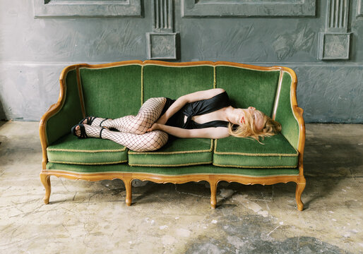 Portrait Of  transgender person alone  on the green sofa