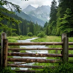 Fototapeta premium Wooden fence is located in the middle of green grass 