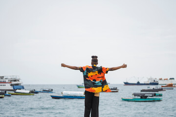 Person embracing freedom in front of the sea