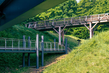 Iron bridge structure. Iron footbridge in nature. Barrier-free access in nature to a high hill. Construction, iron, material.