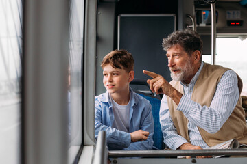 Grandad and grandson riding bus
