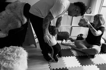 Black and white photo of family playtime