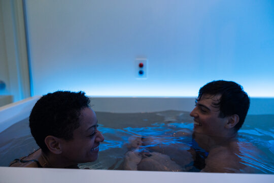 Two people in a flotation tank facing each other