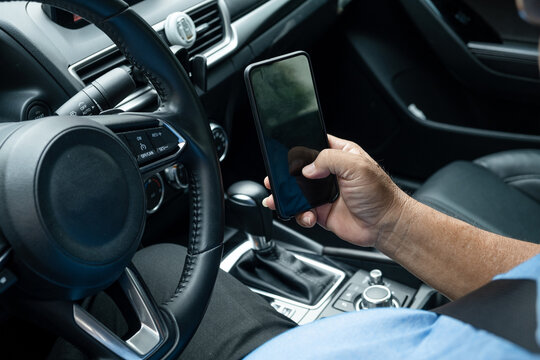 Businessman using mobile phone in the car