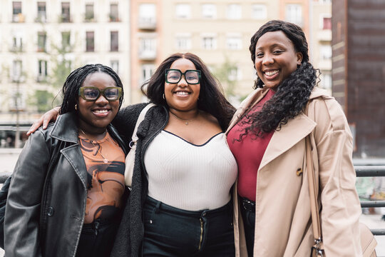 Three friends women looking at camera