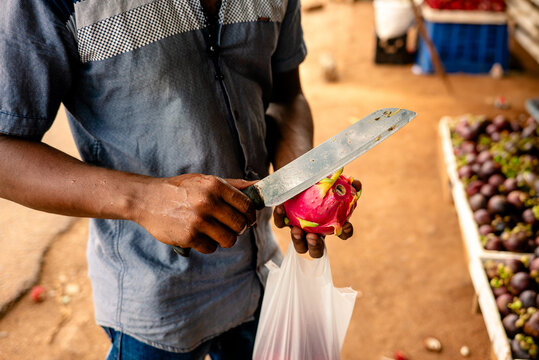 Man preparing Dragon Fruit