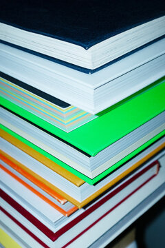 Colorful pile/stack of books in business office with direct flashlight