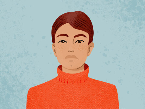 Young man standing in room with blue wall