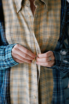 Woman trying on shirt 