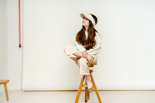 Pensive girl Sitting on Stool