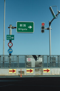 Japanese street sign at an intersection 