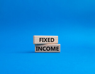 Fixed Income symbol. Concept word Fixed Income on wooden blocks. Beautiful blue background. Business and Fixed Income concept. Copy space