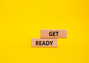 Get ready symbol. Wooden blocks with words Get ready. Beautiful yellow background. Business and Get...