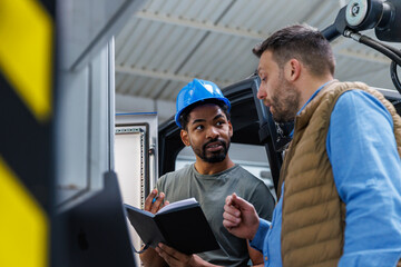 Technician and engineer discussing in industry