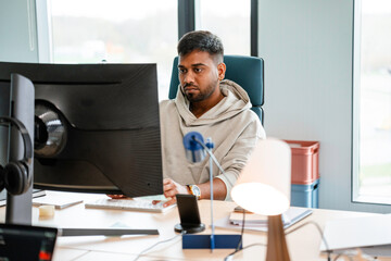 A man uses a computer in the office
