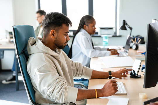 A man uses a computer in the office