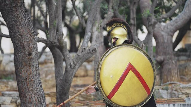 Spartan hoplite warrior going forward in attack with sword