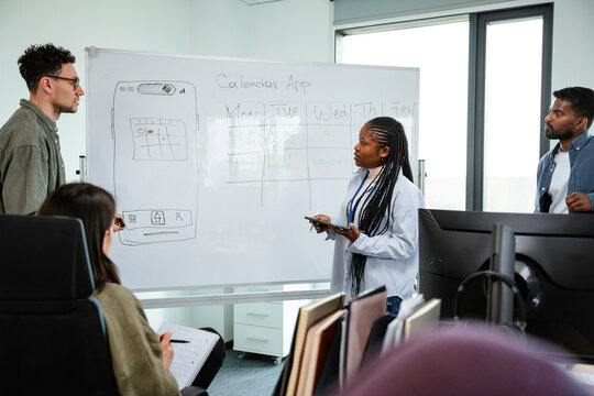A man and a woman are developing a mobile application