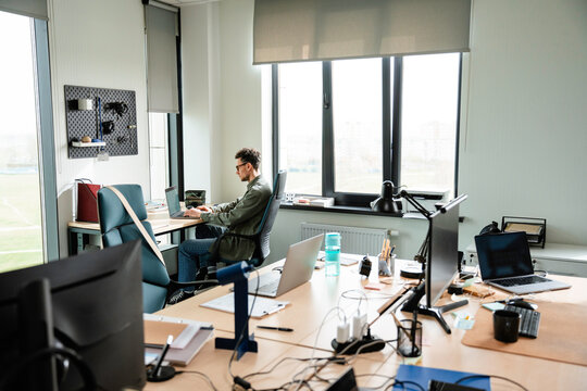 A man uses a laptop in the office