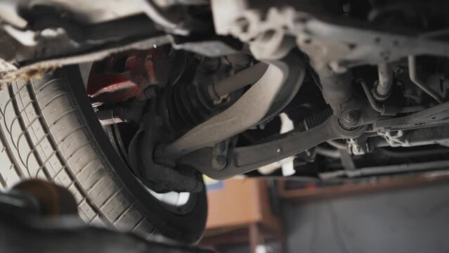 Car disk brake pad replacement service by hand of mechanic man in car garage