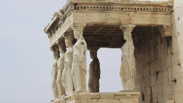 The Caryatids of Erechtheion Temple (Erechtheum) at the archaeological site of Acropolis. Caryatids are sculpted female figures used as decorative architectural support in place of columns or pillars