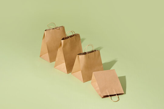 Shopping brown recycle gift bags isolated on green background