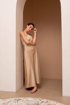 Elegant woman posing in arched doorway 