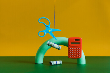 The set with a  hanging calculator and scissors cutting a rope