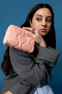 Young woman with money purse in room