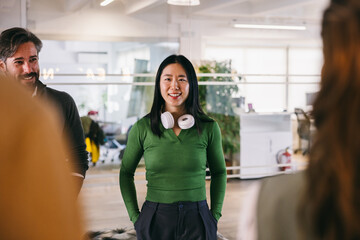 Confident young asian woman at a casual office meeting