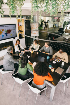 Diverse team engaging in a business meeting at a modern office