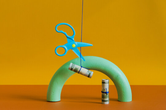 The set with a  hanging money and scissors cutting a rope