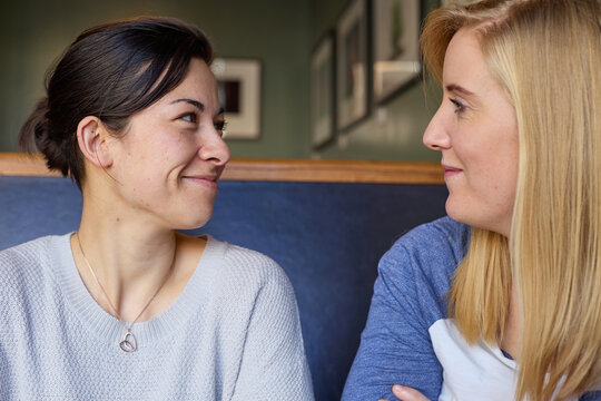 Lesbian couple in conversation at cafe
