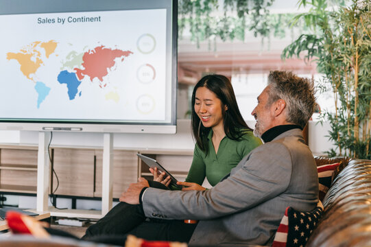 Business professionals analyzing global sales data