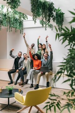 Diverse team celebrating success in modern office