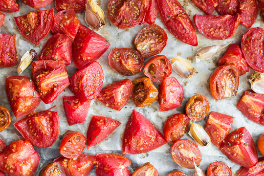 Oven-Roasted Tomatoes With Garlic on Baking Sheet
