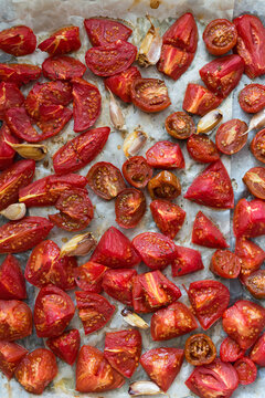 Oven-Roasted Tomatoes With Garlic on Baking Sheet