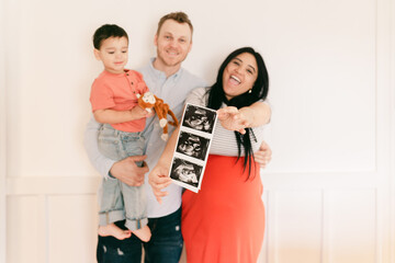 happy smiling family announcing arrival of new baby. 