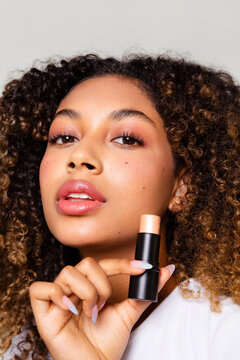 Portrait of a woman holding a stick illuminator